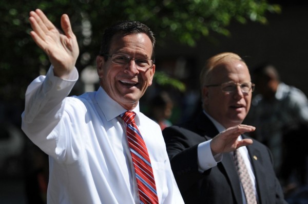 Connecticut Gov. Dannel P. Malloy, left, and Danbury Mayor Mark Boughton wave to the crowd while walking in the Danbury Memorial Day parade on Main Street in Danbury, Conn. on Monday, May 27, 2013.  The parade began at Rose Street and Main Street, finishing at Rogers Park, where skydivers dropped onto the field at Rogers Park Middle School.  The parade was followed by a memorial service at the Rogers Park Rose Memorial Garden.