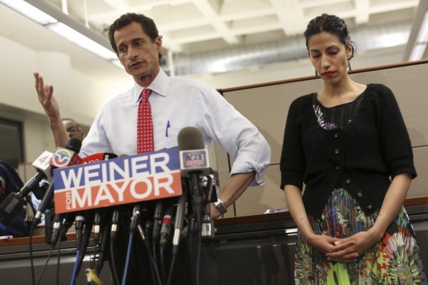 FILE-- New York mayoral candidate Anthony Weiner and his wife Huma Abedin, a top aide to Hillary Rodham Clinton, during a news conference at the Gay Men's Health Crisis offices in New York, July 23, 2013. Huma Abedin’s decision to stand at her husband's side has evoked popular comparisons with the scandals endured by Bill and Hillary Clinton in the 1990s. (Michael Appleton/The New York Times)