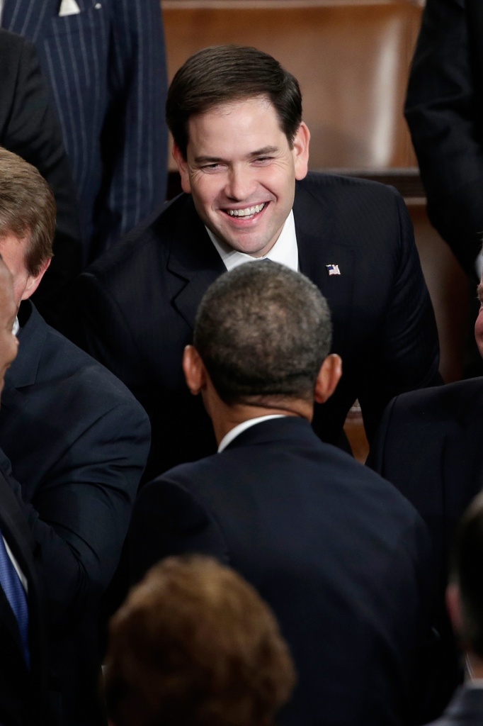  WASHINGTON, DC - JANUARY 28: U.S. President Barack Obama greets U.S. Sen Marco Rubio (R-FL) (top) before delivering the State of the Union address to a joint session of Congress in the House Chamber at the U.S. Capitol on January 28, 2014 in Washington, DC. In his fifth State of the Union address, Obama is expected to emphasize on healthcare, economic fairness and new initiatives designed to stimulate the U.S. economy with bipartisan cooperation. (Photo by Win McNamee/Getty Images)
