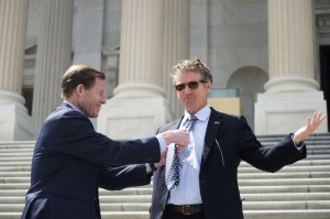 Sen. Richard Blumenthal adjusts his Husky-logo UConn tie _ on Sen. Rand Paul, R-Kentucky, who lost a bet on the NCAA men's basketball championship game and had to don the tie on the Capitol's Senate steps. (Photo by Will Brown)