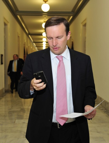 U.S. Rep. Chris Murphy (D-Conn.) looks at his Blackberry as he walks to the U.S. Capitol for a series of votes in this September 20, 2012 file photo.