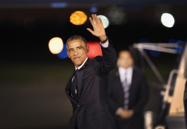 GARY, IN - OCTOBER 01:  U.S. President Barack Obama waves after stepping off Air Force One at Gary/Chicago International Airport to begin a two-day visit to the Chicago area on October 1, 2014 in Gary, Indiana. The president's plane landed in Gary instead of Chicago because Chicago's O'Hare International Airport is still struggling to return to normal flight operations following last weeks sabotage of a suburban FAA radar facility by a contract worker. The sabotage disrupted air travel nationwide and caused more than 2,000 flights to be cancelled at O'Hare airport.  (Photo by Scott Olson/Getty Images)