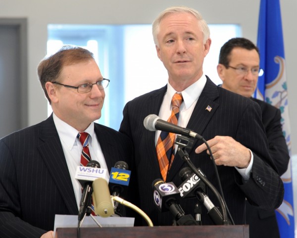 Stratford Mayor John Harkins (left) and Bridgeport Mayor Bill Finch share the podium as they speak prior to the signing of documents resolving the long disputed construction of a new runway safety zone at Sikorsky Memorial Airport, in Stratford, Conn., April 17th, 2013.