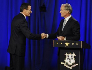 Incumbent Democrat Gov. Dannel P. Malloy, left, and Republican candidate for governor Tom Foley greet at the end of a debate, Thursday, Oct. 9, 2014, in Hartford, Conn.