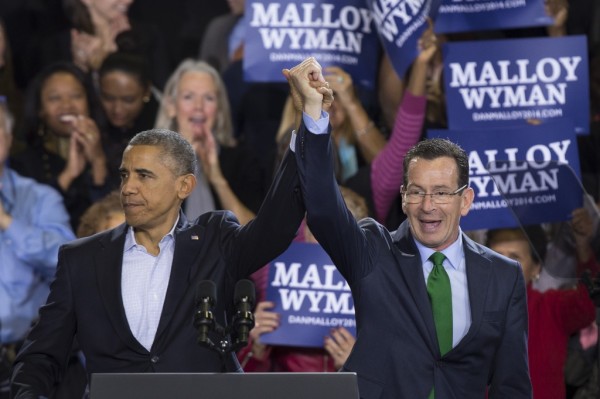 President Barack Obama raises the hand of Connecticut Gov. Dannel P. Malloy, right, during a rally at Central High School in Bridgeport, Conn. Sunday, Nov. 2, 2014. Obama visited Bridgeport to rally the heavily Democratic city in an effort to re-elect Malloy in Tuesday's midterm election where he will rematch with GOP candidate Tom Foley. (AP Photo/John Minchillo)