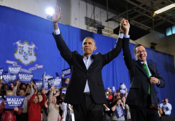President Barack Obama and Connecticut Gov. Dannel P. Malloy thanks the crowd after speaking at Central High School in Bridgeport, Conn. Sunday, Nov. 2, 2014.  President Obama visited Bridgeport to rally the heavily Democratic city in an effort to re-elect Democrat Gov. Dannel P. Malloy in November's midterm election. FILE PHOTO